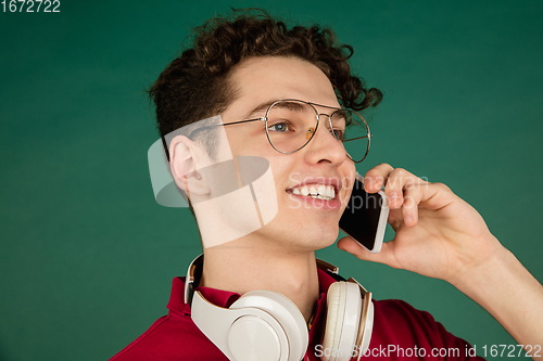 Image of Caucasian man\'s portrait isolated on green studio background with copyspace