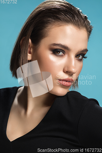 Image of Portrait of female fashion model isolated on blue studio background. Style and beauty concept. Close up.