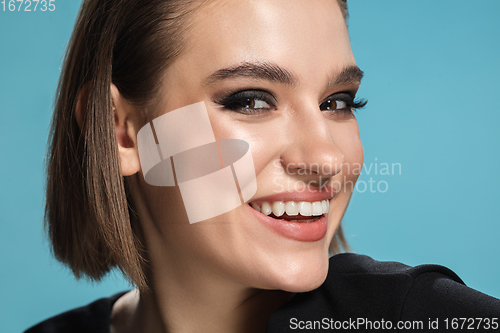 Image of Portrait of female fashion model isolated on blue studio background. Style and beauty concept. Close up.