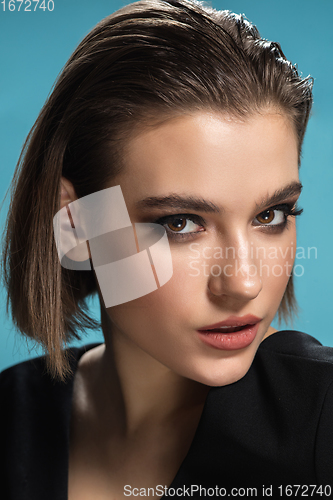 Image of Portrait of female fashion model isolated on blue studio background. Style and beauty concept. Close up.