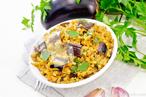 Image of Bulgur with eggplant in bowl on table
