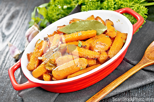 Image of Carrots fried in pan on black board