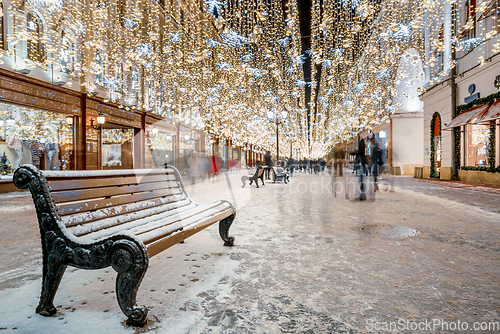 Image of Christmas market stalls and Christmas street light decoration.