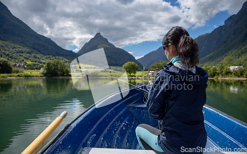 Image of Woman fishing on Fishing rod spinning in Norway.