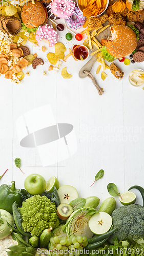 Image of Fast and healthy food compared on white background. Unhealthy set including burgers, sauces, french fries in comparison with vegetables, fruits, organic food