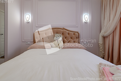 Image of Beige and brown modern bedroom interior with double bed