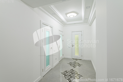 Image of interior of white hallway with doors