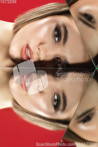 Image of Portrait of female fashion model with reflections on mirrors around her face. Style and beauty concept. Close up.