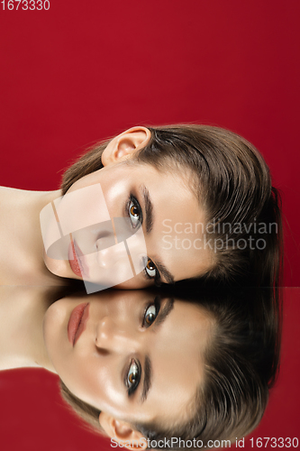 Image of Portrait of female fashion model with reflections on mirrors around her face. Style and beauty concept. Close up.