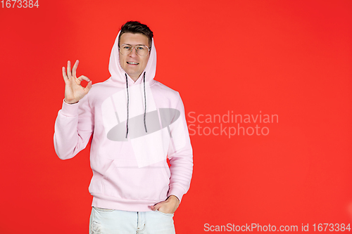 Image of Caucasian man\'s portrait isolated on red studio background with copyspace