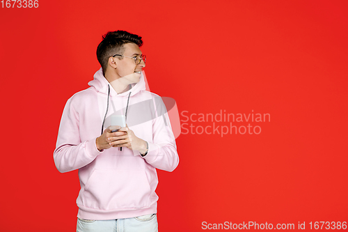 Image of Caucasian man\'s portrait isolated on red studio background with copyspace