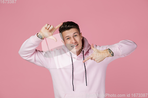 Image of Caucasian man\'s portrait isolated on pink studio background with copyspace