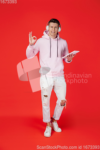 Image of Caucasian man\'s portrait isolated on red studio background with copyspace