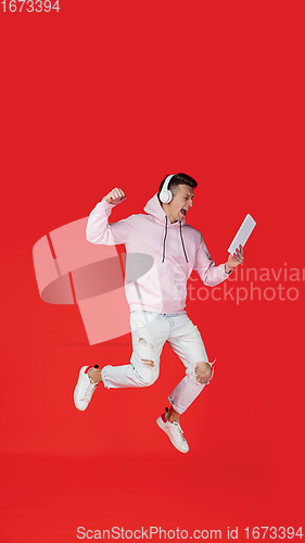 Image of Caucasian man\'s portrait isolated on red studio background with copyspace