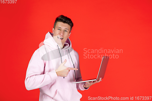 Image of Caucasian man\'s portrait isolated on red studio background with copyspace