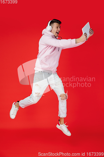 Image of Caucasian man\'s portrait isolated on red studio background with copyspace