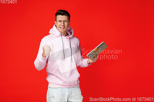 Image of Caucasian man\'s portrait isolated on red studio background with copyspace