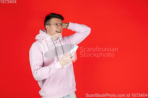 Image of Caucasian man\'s portrait isolated on red studio background with copyspace