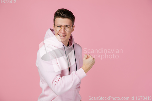 Image of Caucasian man\'s portrait isolated on pink studio background with copyspace