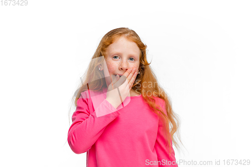 Image of Happy redhair girl isolated on white studio background. Looks happy, cheerful, sincere. Copyspace. Childhood, education, emotions concept