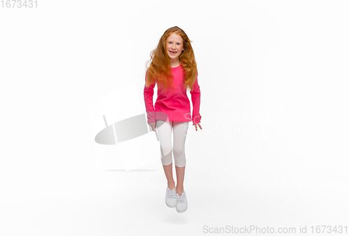 Image of Happy redhair girl isolated on white studio background. Looks happy, cheerful, sincere. Copyspace. Childhood, education, emotions concept