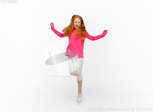 Image of Happy redhair girl isolated on white studio background. Looks happy, cheerful, sincere. Copyspace. Childhood, education, emotions concept