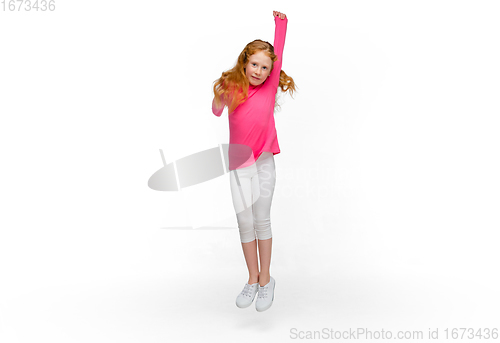 Image of Happy redhair girl isolated on white studio background. Looks happy, cheerful, sincere. Copyspace. Childhood, education, emotions concept