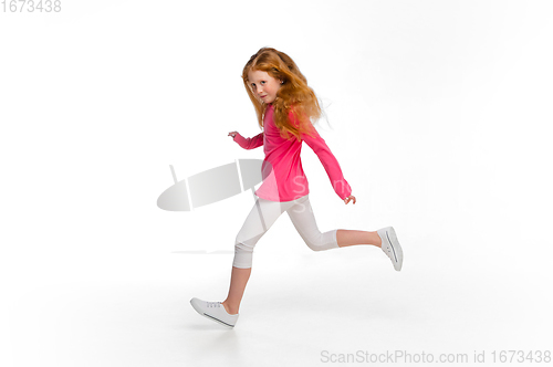 Image of Happy redhair girl isolated on white studio background. Looks happy, cheerful, sincere. Copyspace. Childhood, education, emotions concept