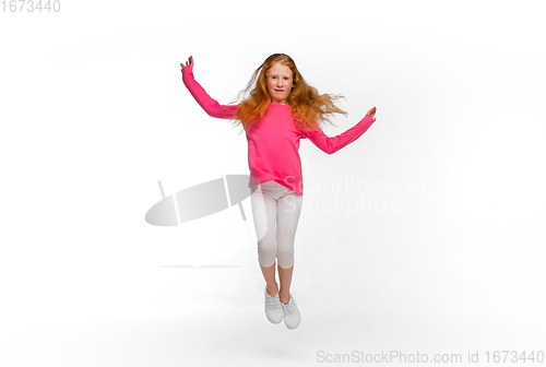 Image of Happy redhair girl isolated on white studio background. Looks happy, cheerful, sincere. Copyspace. Childhood, education, emotions concept