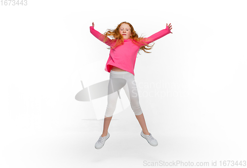 Image of Happy redhair girl isolated on white studio background. Looks happy, cheerful, sincere. Copyspace. Childhood, education, emotions concept