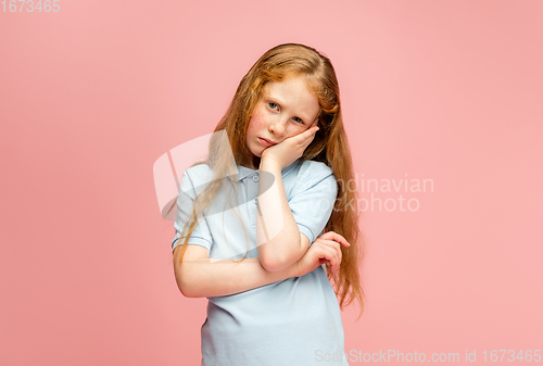 Image of Happy redhair girl isolated on pink studio background. Looks happy, cheerful, sincere. Copyspace. Childhood, education, emotions concept