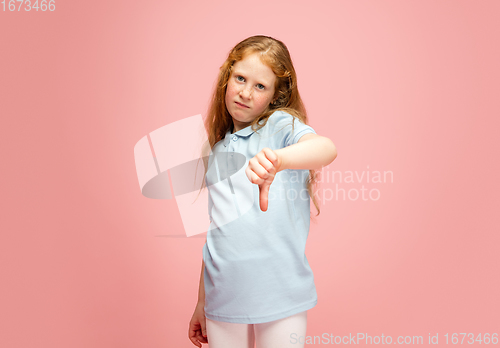 Image of Happy redhair girl isolated on pink studio background. Looks happy, cheerful, sincere. Copyspace. Childhood, education, emotions concept