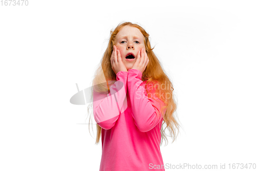 Image of Happy redhair girl isolated on white studio background. Looks happy, cheerful, sincere. Copyspace. Childhood, education, emotions concept