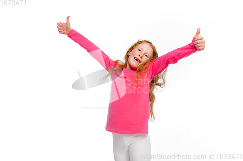 Image of Happy redhair girl isolated on white studio background. Looks happy, cheerful, sincere. Copyspace. Childhood, education, emotions concept