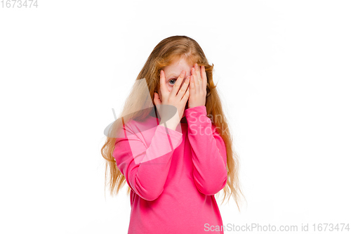 Image of Happy redhair girl isolated on white studio background. Looks happy, cheerful, sincere. Copyspace. Childhood, education, emotions concept