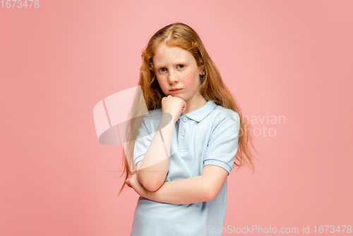 Image of Happy redhair girl isolated on pink studio background. Looks happy, cheerful, sincere. Copyspace. Childhood, education, emotions concept