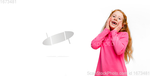 Image of Happy redhair girl isolated on white studio background. Looks happy, cheerful, sincere. Copyspace. Childhood, education, emotions concept