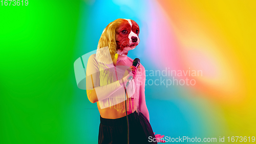 Image of Talented dog, professional musician performing on multicoloted background in neon light. Concept of music, hobby, festival, contemporary art collage. Modern design.