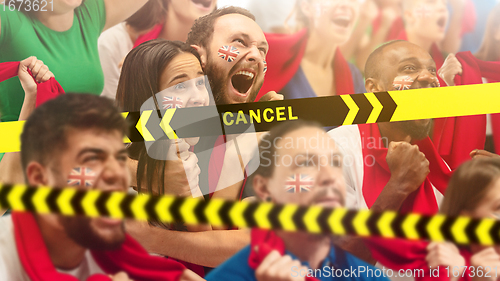 Image of Britainian soccer fans cheering for favourite sport team with bright emotions, excited, wondered behind the limiting tapes with Lockdown