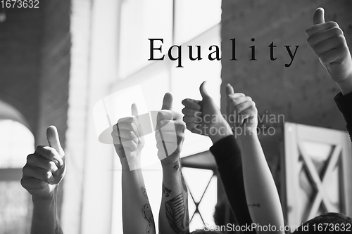 Image of African and caucasian hands gesturing on gray studio background, tolerance and equality concept
