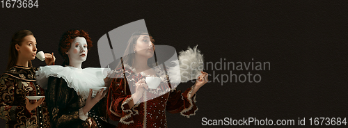 Image of Medieval people as a royalty persons in vintage clothing on dark background. Concept of comparison of eras, modernity and renaissance, baroque style.