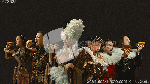 Image of Medieval people as a royalty persons in vintage clothing on dark background. Concept of comparison of eras, modernity and renaissance, baroque style.