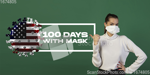 Image of Woman in protective face mask isolated on green studio background. New rules of COVID spreading prevention