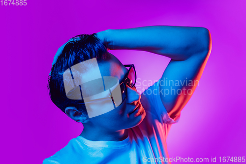 Image of Caucasian man\'s portrait isolated on purple blue studio background in multicolored neon light