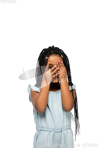 Image of Happy longhair brunette little girl isolated on white studio background. Looks happy, cheerful, sincere. Copyspace. Childhood, education, emotions concept