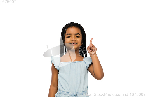 Image of Happy longhair brunette little girl isolated on white studio background. Looks happy, cheerful, sincere. Copyspace. Childhood, education, emotions concept