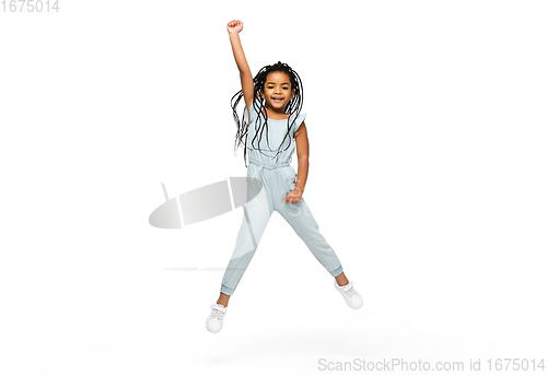 Image of Happy longhair brunette little girl isolated on white studio background. Looks happy, cheerful, sincere. Copyspace. Childhood, education, emotions concept