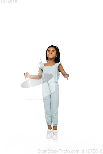 Image of Happy longhair brunette little girl isolated on white studio background. Looks happy, cheerful, sincere. Copyspace. Childhood, education, emotions concept