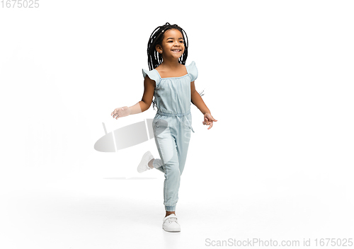 Image of Happy longhair brunette little girl isolated on white studio background. Looks happy, cheerful, sincere. Copyspace. Childhood, education, emotions concept