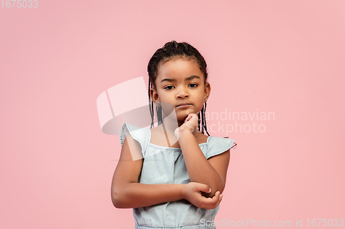 Image of Happy longhair brunette little girl isolated on pink studio background. Looks happy, cheerful, sincere. Copyspace. Childhood, education, emotions concept